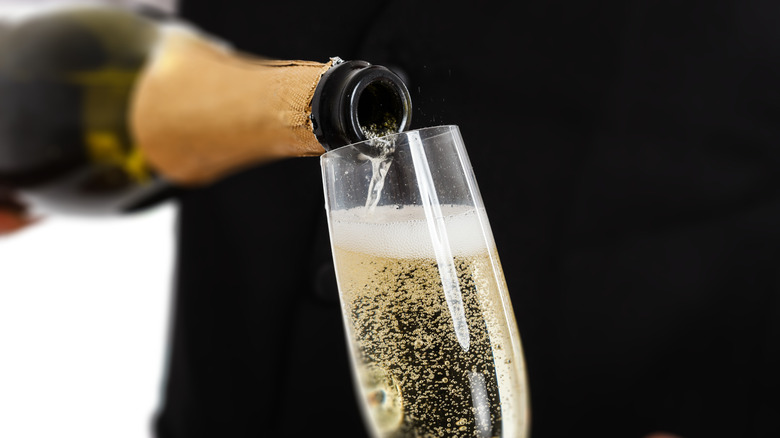 Sparklng wine being poured into Champagne flute
