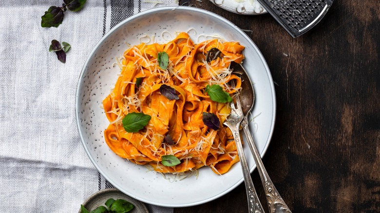 Plate of pasta alla vodka with basil