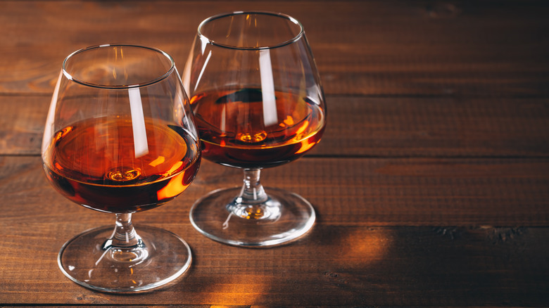 cups of cognac brandy on a wooden counter