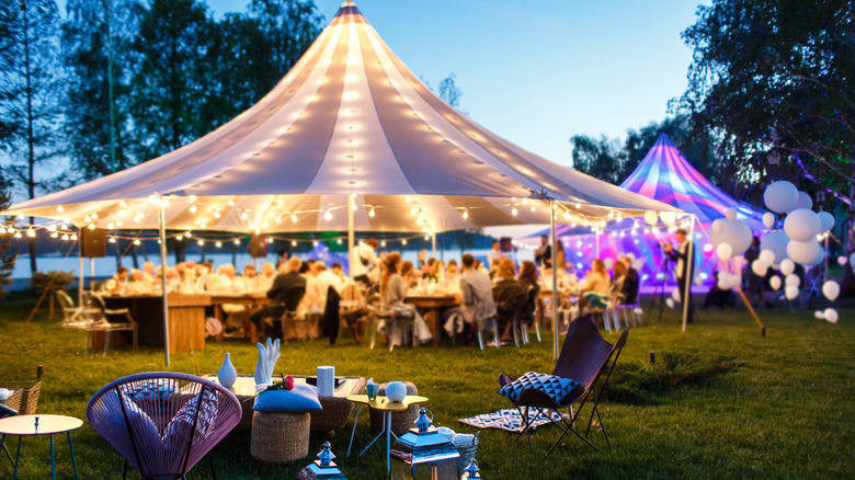 Formal wedding celebration with illuminated tents and white circular baloons