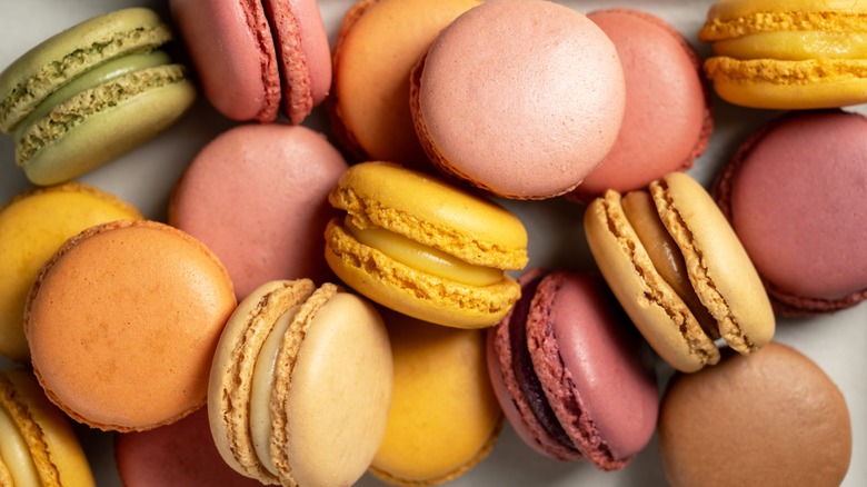 Multicolored macarons stacked on counter