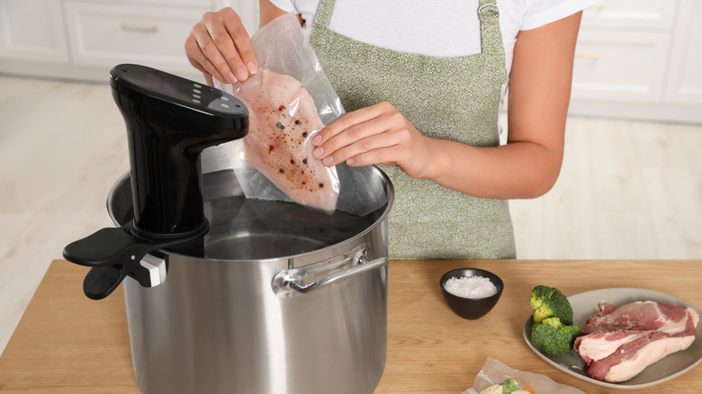 Packaged chicken breast going into a sous vide