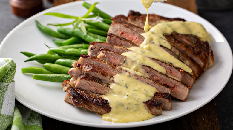 Overcooked steak with creamy bearnaise sauce and green beans