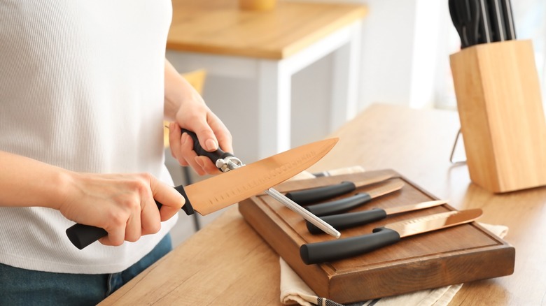 Woman sharpening knives