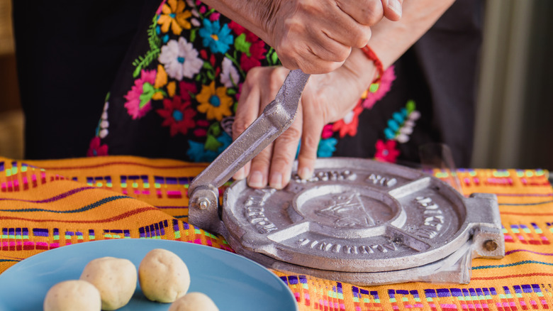 woman using tortilla press