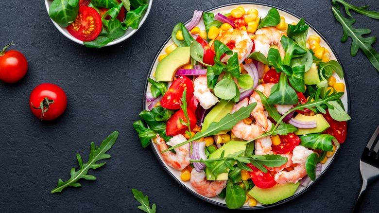 Salad with avocado, shrimp, corn, and red onion
