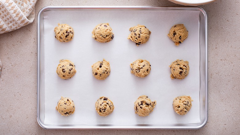 Cookie dough balls on baking sheet