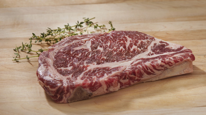 Marbled raw ribeye steak