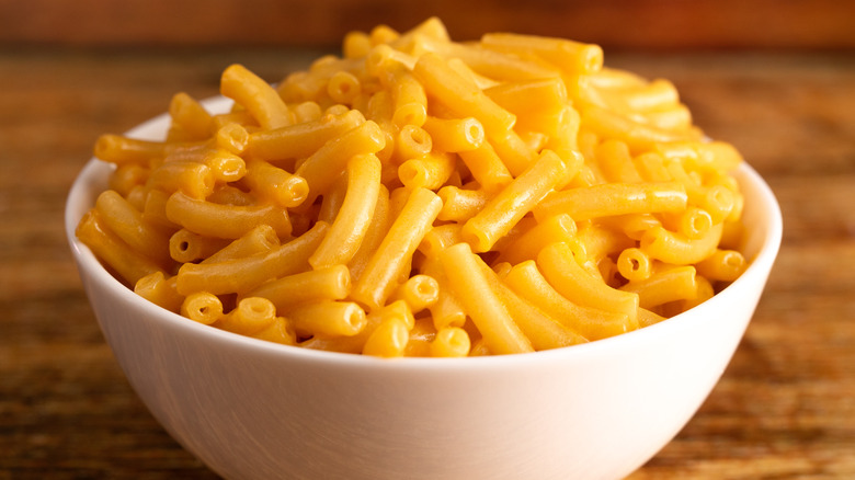 Three boxes of Cheetos Mac 'N Cheese stacked on a gray surface