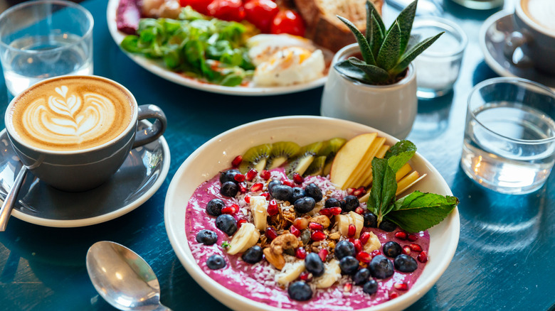 Colorful breakfast dishes with a frothy cappuccino