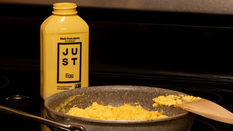 Vegan Just Egg scramble in pan with spatula on stove