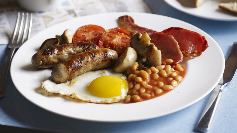 English breakfast with egg, toast, tomatoes, bacon and sausage