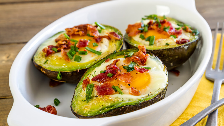 baked avocados and eggs garnished with bacon bits