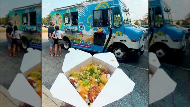 Person holding a box of food in front of a food truck