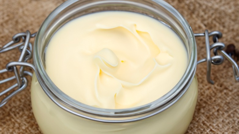 Glass jar of homemade beef tallow for cooking
