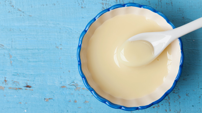 Sweetened condensed milk in bowl with spoon