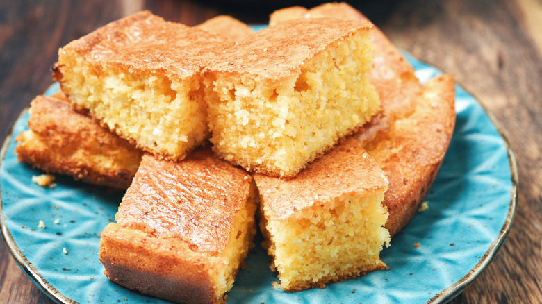 Stacked slices of cornbread on a blue plate 