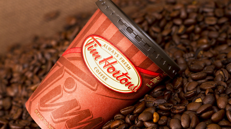 Tim Hortons cup in pile of coffee beans
