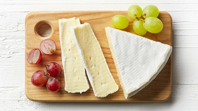 Wedge of brie on cutting board