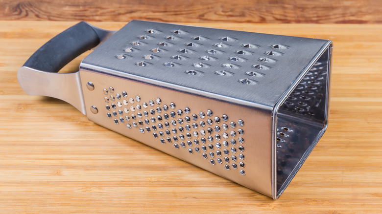 box grater on wooden surface