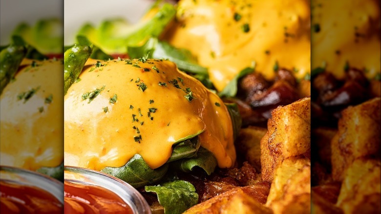 Avocado and bacon benedict with home fries