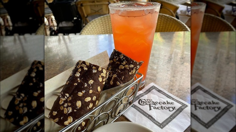 Brown bread in metal basket with paper napkin from Cheesecake Factory