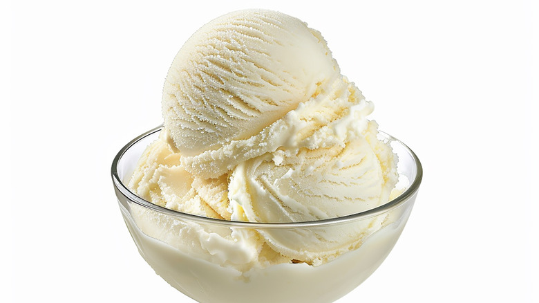 A bowl with three scoops of vanilla ice cream.