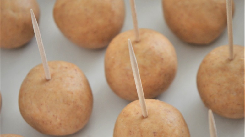 making buckeyes with toothpicks in filling