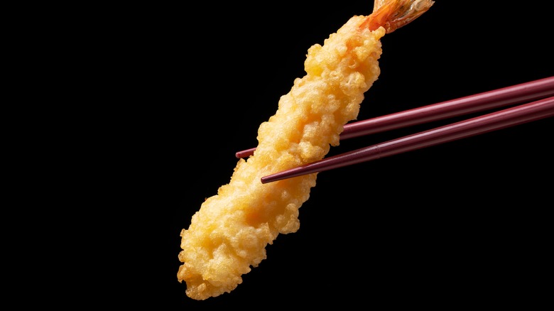 Chopstick holding a piece of tempura
