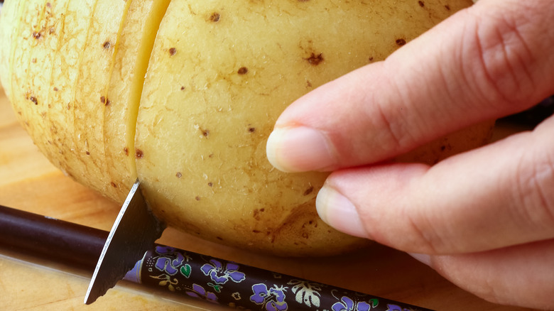 using chopsticks to cut hasselback potatoes