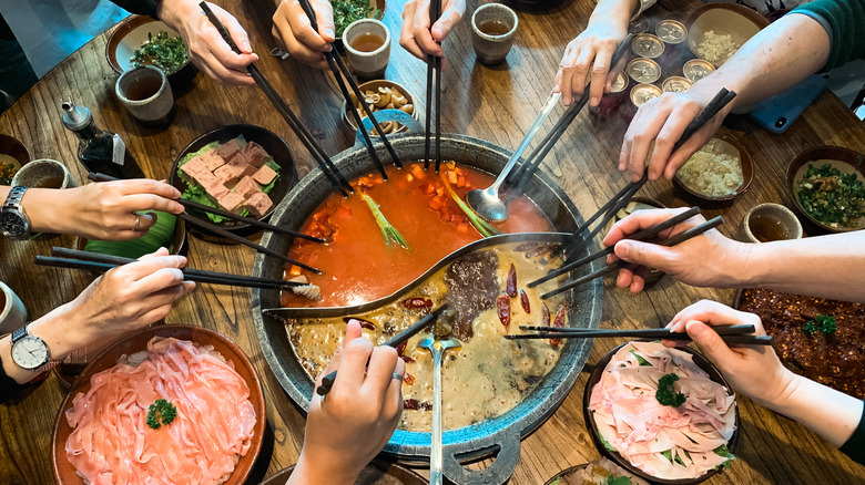 People sharing a hot pot
