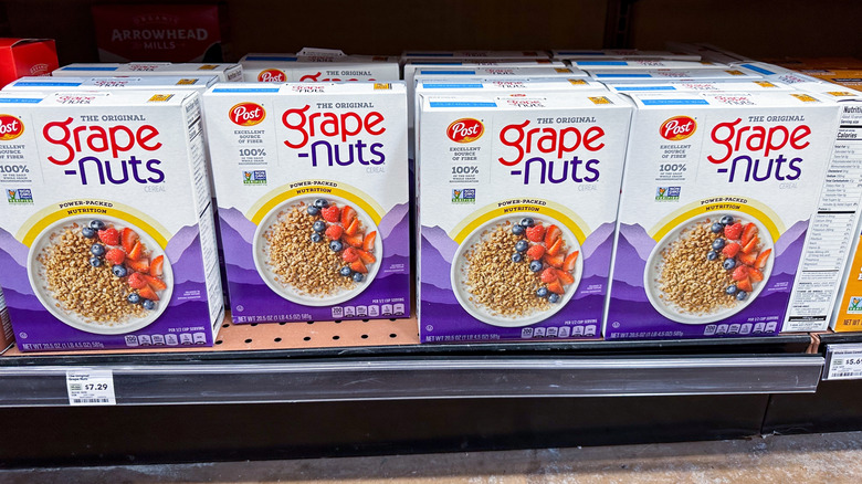 Grape-nuts cereal boxes on grocery store shelf.