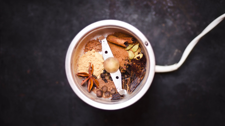 Multiple spices in a coffee grinder.