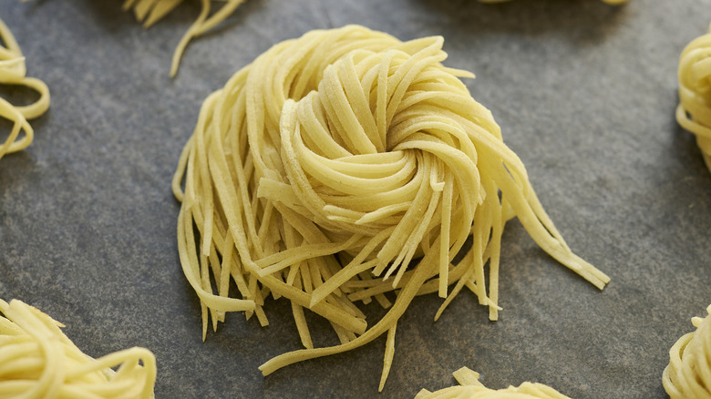 Bundle of fresh homemade pasta on table