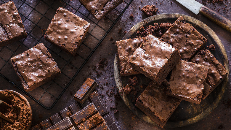 Bowl of brownies next to brownies cooling on wire rack