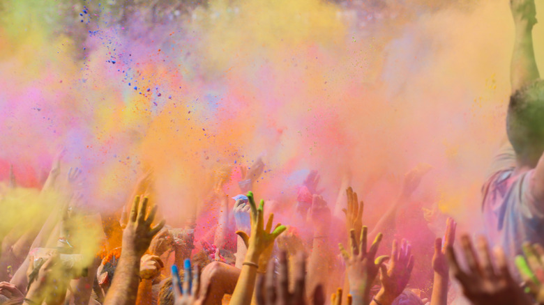 People throwing color in the air for Holi