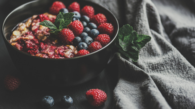 Quinoa breakfast bowl with mint, goji berries, blueberries, and raspberries