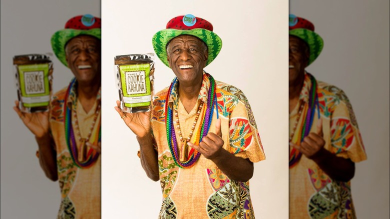 Wally Amos holding a bag of The Cookie Kahuna