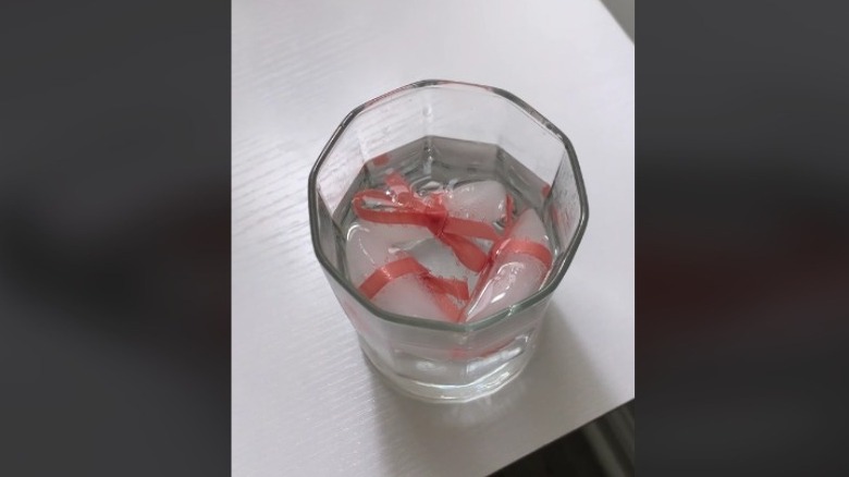 cocktail with pink ribbon garnish