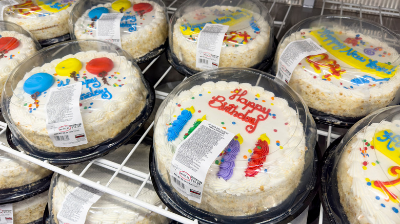 Decorated celebratory cakes sit inside a Special Orders cooler at a Costco location