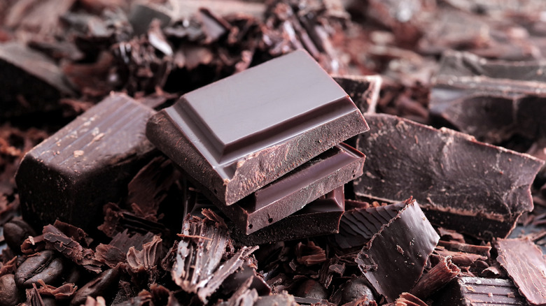 Pieces of chocolate piled atop chocolate shavings and fragments