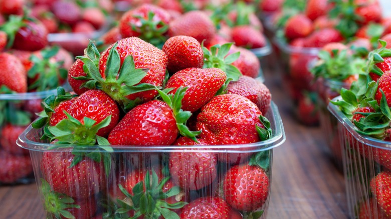 Close-up of plastic containers of strawberries