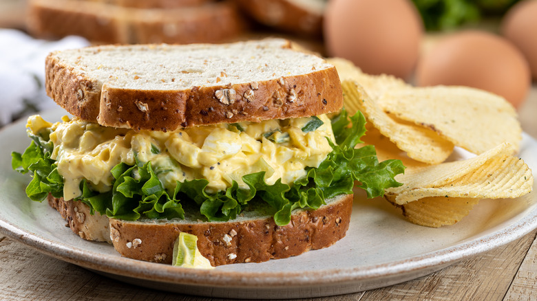 egg salad sandwich paired with salty potato chips