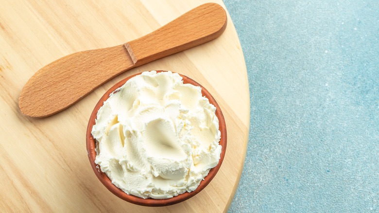 Wooden bowl of softened cream cheese