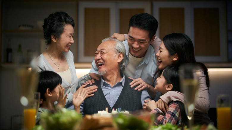 Korean family surrounding grandfather