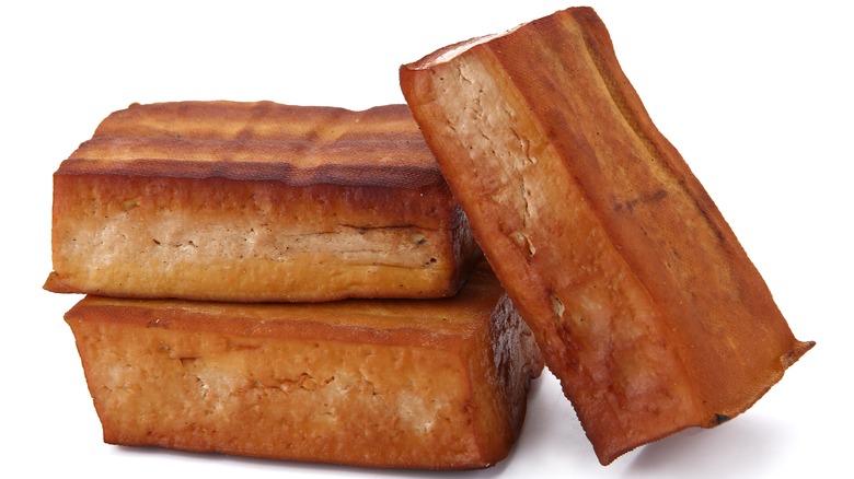 Smoked tofu blocks on a white background