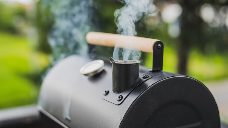 Smoke billowing from a smoker grill