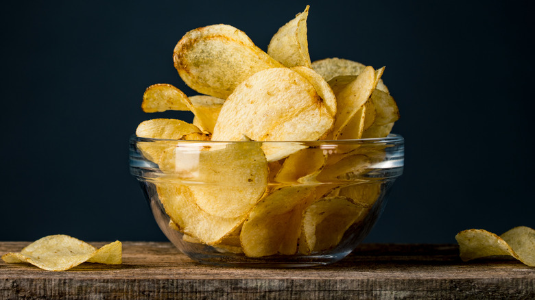 bowl of potato chips on wooden table