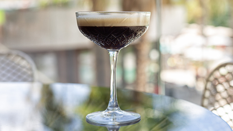 Cocktail glass of shakerato coffee on cafe table