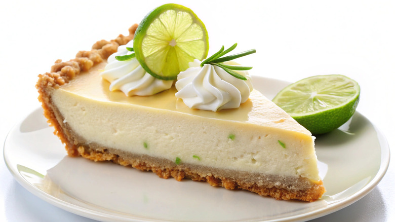 Slice of key lime pie on white plate